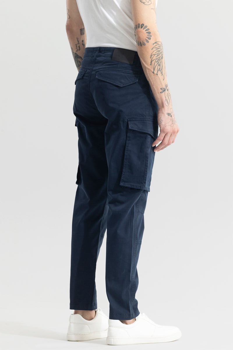 Trekyoo men's navy cargo pants with multiple pockets worn with white sneakers and white shirt